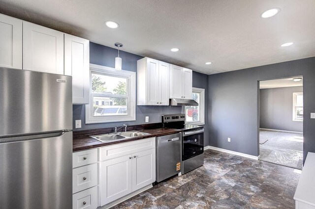 805 E Burgess St, Mount Vernon, OH 43050 - kitchen featuring appliances with stainless steel finishes, under cabinet range hood, wooden counters, plenty of natural light, and recessed lighting