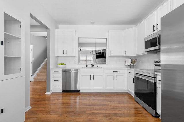 6166 Albany Crest Ave, New Albany, OH 43054 - kitchen with stainless steel appliances, backsplash, white cabinets, and light countertops