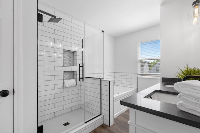 6166 Albany Crest Ave, New Albany, OH 43054 - bathroom featuring a stall shower, double vanity, a bath, and wood finished floors