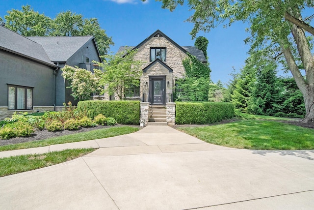2946 Lewis Center Rd, Lewis Center, OH 43035 - tudor house with stone siding, a front yard, and stucco siding