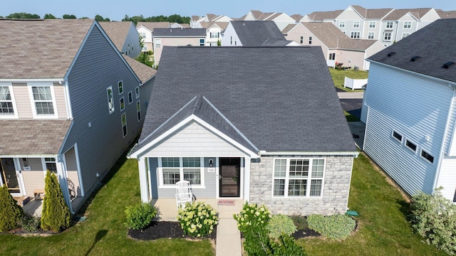 5442 Goose Falls Dr, Dublin, OH 43016 - rear view of property featuring stone siding, a residential view, a shingled roof, and a yard