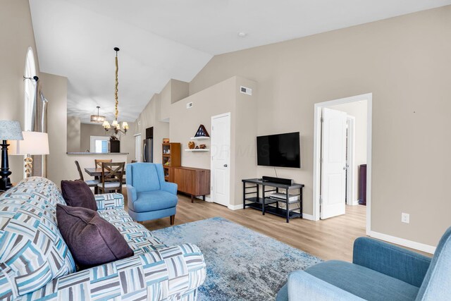 5442 Goose Falls Dr, Dublin, OH 43016 - living room featuring a chandelier, light wood-type flooring, and high vaulted ceiling