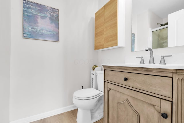 5442 Goose Falls Dr, Dublin, OH 43016 - bathroom featuring vanity, wood finished floors, and a shower with shower door