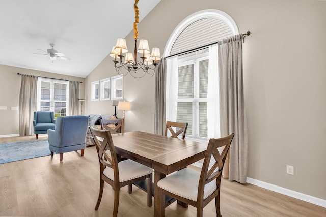 5442 Goose Falls Dr, Dublin, OH 43016 - dining space with light wood-style flooring, a chandelier, vaulted ceiling, and a ceiling fan