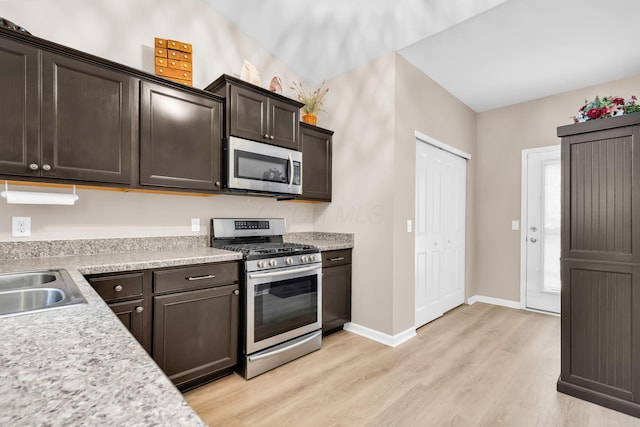 5442 Goose Falls Dr, Dublin, OH 43016 - kitchen featuring appliances with stainless steel finishes, light wood-style flooring, light countertops, and dark brown cabinets