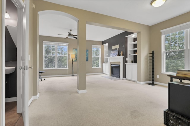 331 Hanton Way, Columbus, OH 43213 - unfurnished living room with carpet flooring, baseboards, a ceiling fan, and a fireplace with flush hearth