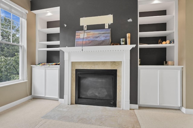 331 Hanton Way, Columbus, OH 43213 - unfurnished living room with baseboards, built in features, a tiled fireplace, and carpet