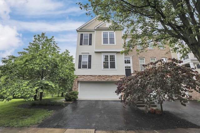 331 Hanton Way, Columbus, OH 43213 - townhome / multi-family property with stone siding, asphalt driveway, and a garage