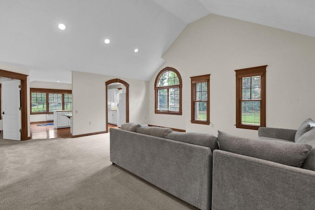 1366 Chapel Way, Heath, OH 43056 - living area with arched walkways, recessed lighting, light colored carpet, and high vaulted ceiling