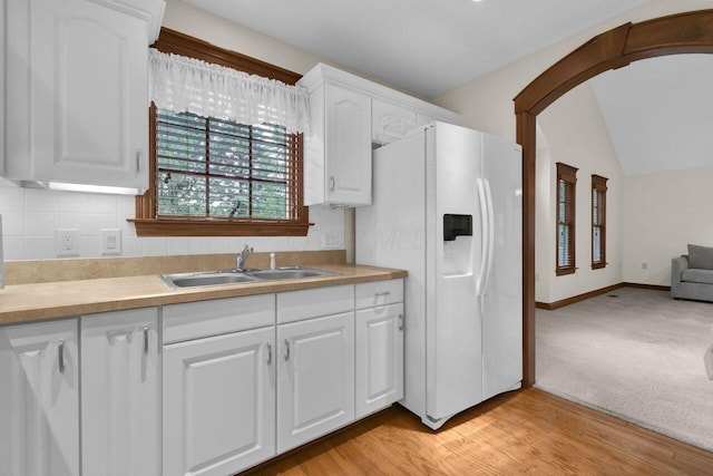 1366 Chapel Way, Heath, OH 43056 - kitchen with white fridge with ice dispenser, tasteful backsplash, white cabinets, vaulted ceiling, and light countertops