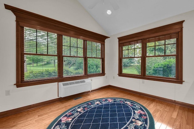 1366 Chapel Way, Heath, OH 43056 - empty room with plenty of natural light, wood finished floors, ceiling fan, vaulted ceiling, and a wall mounted air conditioner