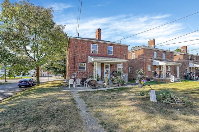 3276-3278 Sullivant Ave, Columbus, OH 43204 - back of house featuring brick siding, a yard, and a chimney