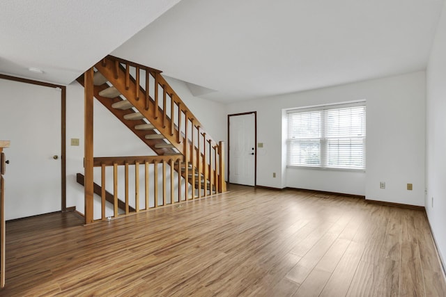 5062 Stoneybrook Blvd Unit 3F, Hilliard, OH 43026 - unfurnished living room featuring wood finished floors and stairway