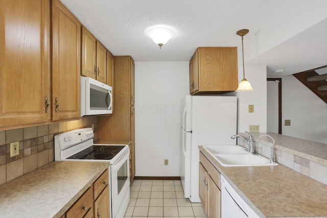 5062 Stoneybrook Blvd Unit 3F, Hilliard, OH 43026 - kitchen with white appliances, decorative backsplash, brown cabinetry, and decorative light fixtures