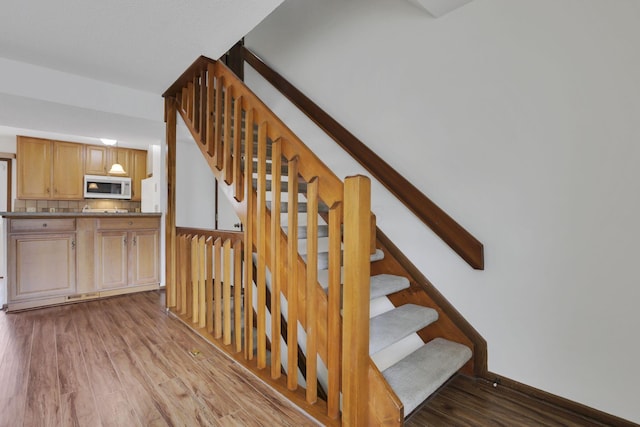 5062 Stoneybrook Blvd Unit 3F, Hilliard, OH 43026 - staircase featuring wood finished floors and baseboards