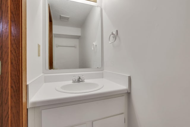 5062 Stoneybrook Blvd Unit 3F, Hilliard, OH 43026 - bathroom featuring vanity and a textured ceiling