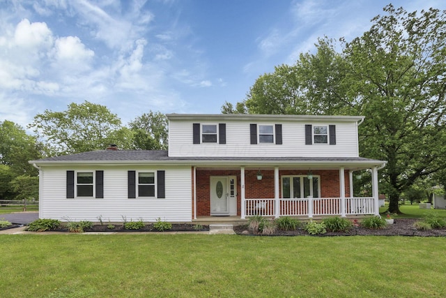 13680 Nantucket Ave NW, Pickerington, OH 43147 - view of front of house featuring a front yard, covered porch, and brick siding