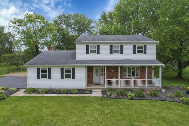13680 Nantucket Ave NW, Pickerington, OH 43147 - view of front of house with a porch, a chimney, a front yard, and brick siding