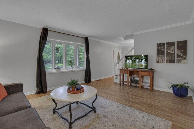 13680 Nantucket Ave NW, Pickerington, OH 43147 - living area featuring stairs, wood finished floors, crown molding, baseboards, and a textured ceiling