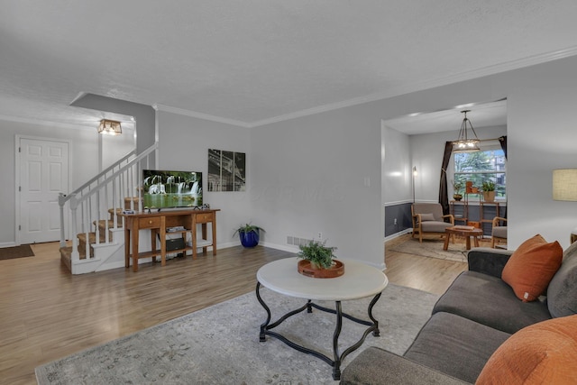 13680 Nantucket Ave NW, Pickerington, OH 43147 - living area with wood finished floors, crown molding, and stairway