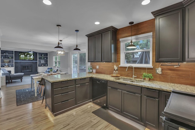 13680 Nantucket Ave NW, Pickerington, OH 43147 - kitchen with black dishwasher, a sink, backsplash, a fireplace, and open floor plan
