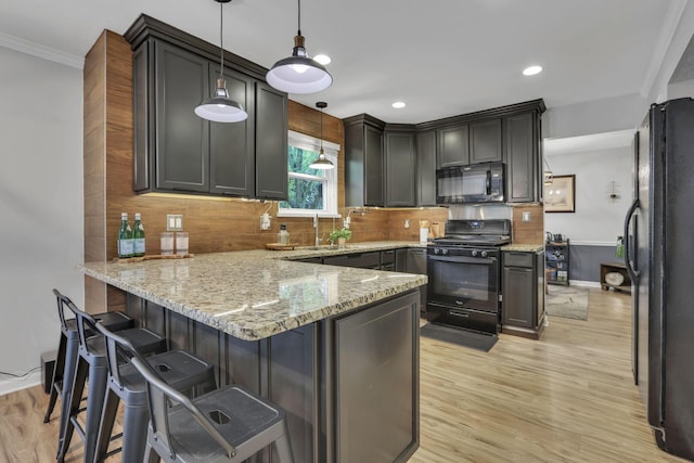13680 Nantucket Ave NW, Pickerington, OH 43147 - kitchen featuring black appliances, a peninsula, light wood-type flooring, light stone counters, and recessed lighting