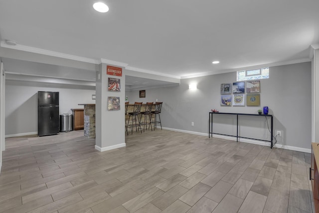13680 Nantucket Ave NW, Pickerington, OH 43147 - basement with freestanding refrigerator, a dry bar, ornamental molding, light wood finished floors, and recessed lighting
