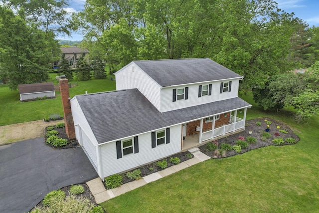 13680 Nantucket Ave NW, Pickerington, OH 43147 - view of front of home with covered porch, a shingled roof, and a front lawn