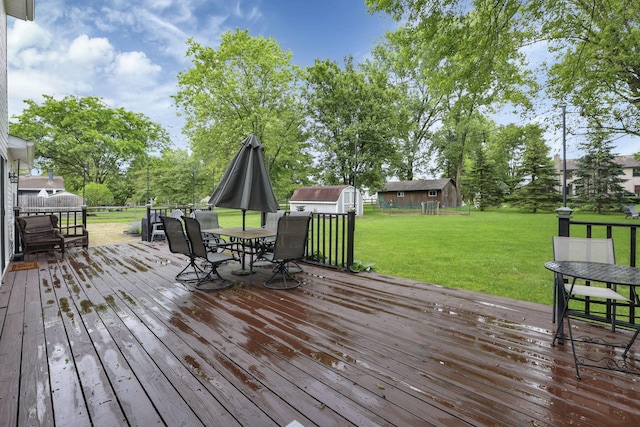 13680 Nantucket Ave NW, Pickerington, OH 43147 - deck with outdoor dining area, a shed, a lawn, and view of scattered trees