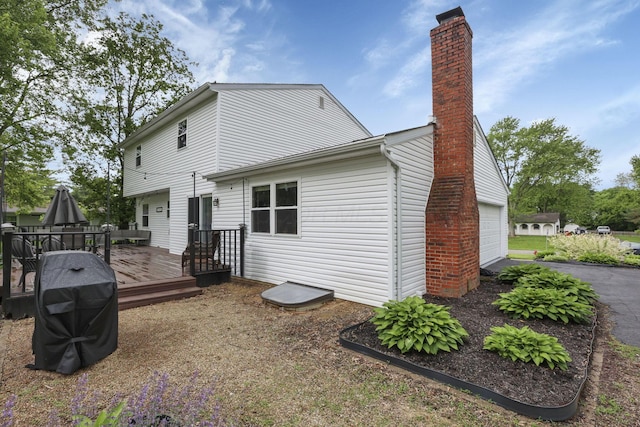13680 Nantucket Ave NW, Pickerington, OH 43147 - back of property with a garage, a chimney, and a deck