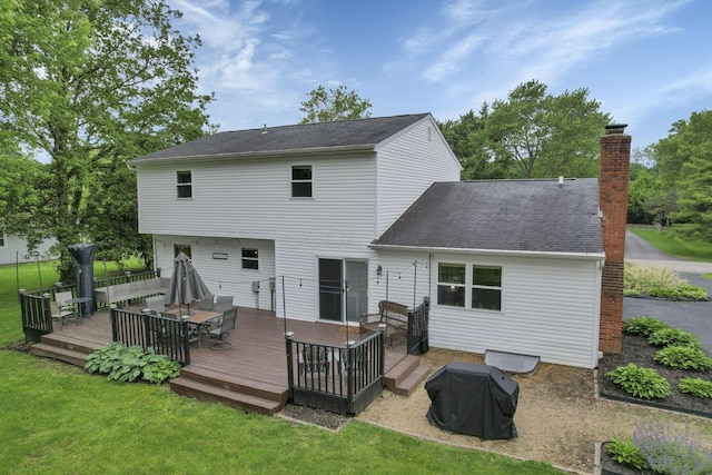 13680 Nantucket Ave NW, Pickerington, OH 43147 - rear view of house with a yard, outdoor dining space, a chimney, a wooden deck, and roof with shingles