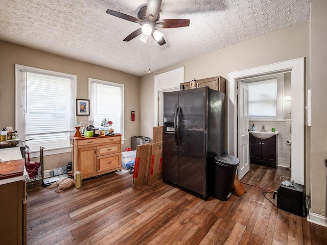 1364-1366 S 3rd St, Columbus, OH 43207 - kitchen featuring black fridge, ceiling fan, dark wood-style flooring, a sink, and a textured ceiling