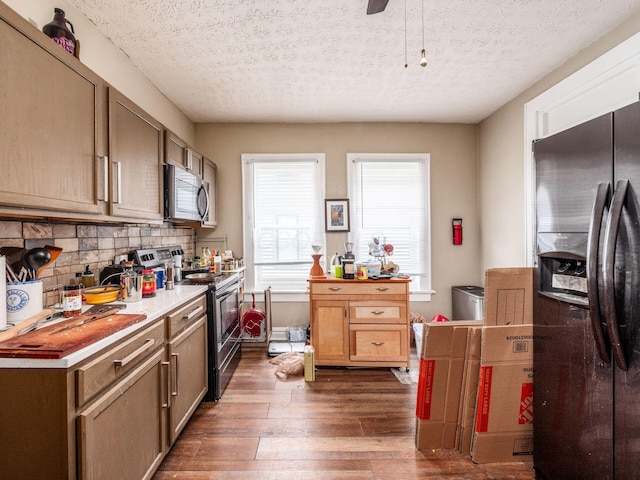 1364-1366 S 3rd St, Columbus, OH 43207 - kitchen featuring stainless steel appliances, dark wood-type flooring, decorative backsplash, light countertops, and a textured ceiling
