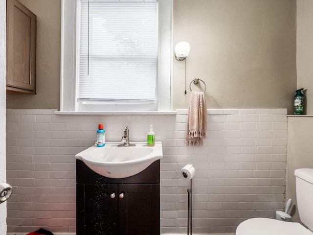 1364-1366 S 3rd St, Columbus, OH 43207 - half bathroom featuring toilet, vanity, tile walls, and a wainscoted wall