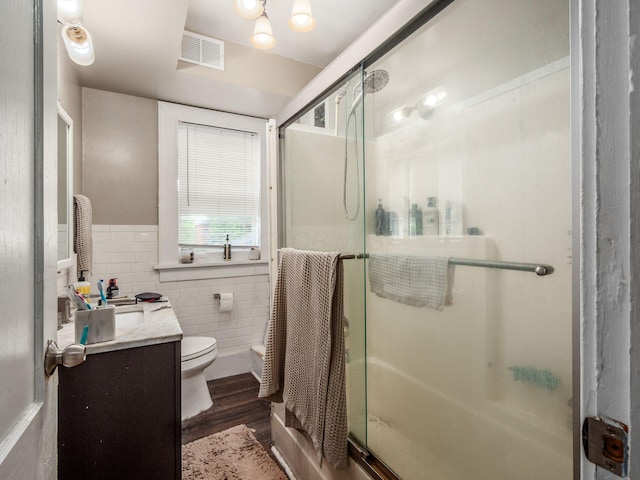 1364-1366 S 3rd St, Columbus, OH 43207 - bathroom with tile walls, vanity, a stall shower, wood finished floors, and toilet