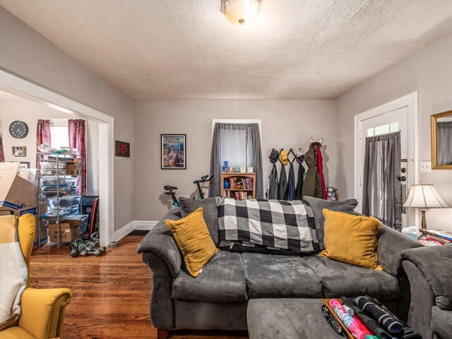 1364-1366 S 3rd St, Columbus, OH 43207 - living room featuring wood finished floors, a textured ceiling, healthy amount of natural light, and baseboards