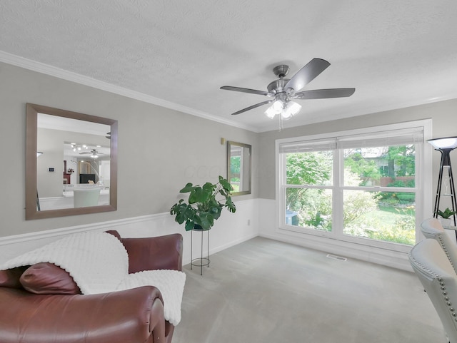 832 Lynnfield Dr, Westerville, OH 43081 - living area featuring carpet flooring, ceiling fan, a wainscoted wall, a textured ceiling, and crown molding