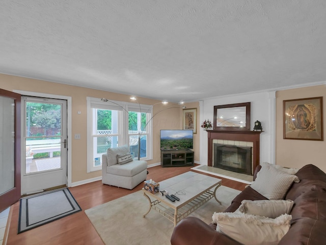 832 Lynnfield Dr, Westerville, OH 43081 - living room with wood finished floors, a textured ceiling, and a tile fireplace