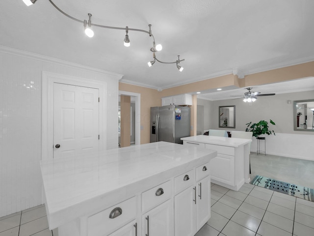832 Lynnfield Dr, Westerville, OH 43081 - kitchen with a kitchen island, stainless steel refrigerator with ice dispenser, crown molding, light tile patterned flooring, and white cabinets