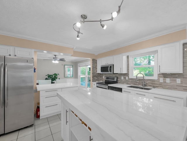 832 Lynnfield Dr, Westerville, OH 43081 - kitchen with stainless steel appliances, ornamental molding, light tile patterned floors, backsplash, and white cabinets