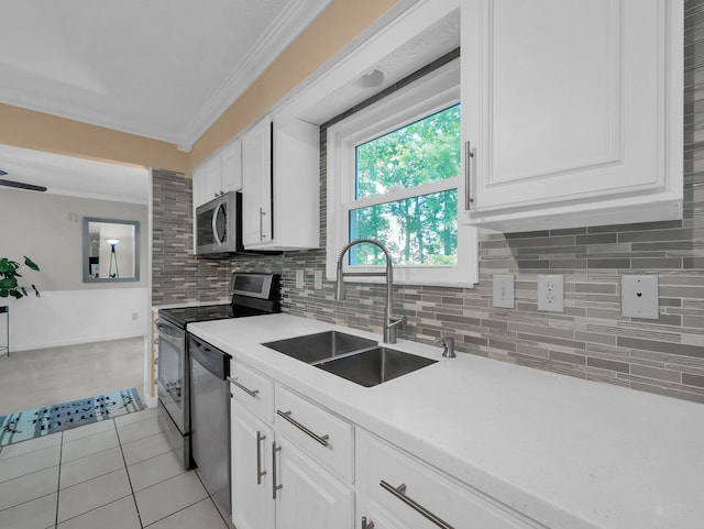832 Lynnfield Dr, Westerville, OH 43081 - kitchen with stainless steel appliances, crown molding, white cabinets, light countertops, and tasteful backsplash