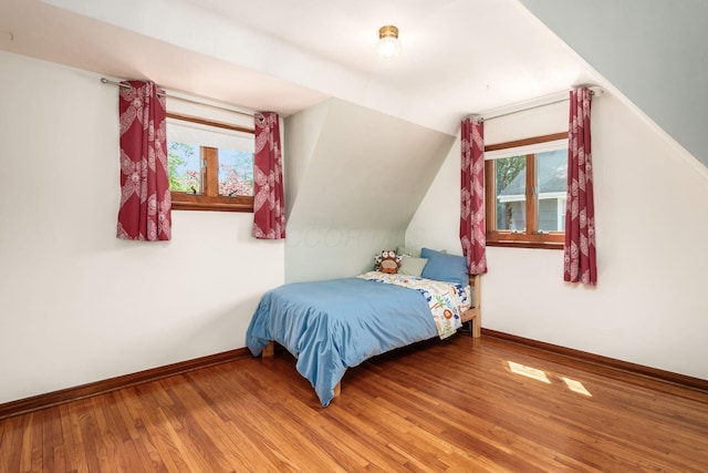 328 Chatham Rd, Columbus, OH 43214 - bedroom featuring multiple windows, wood finished floors, and vaulted ceiling