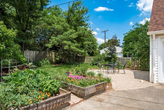328 Chatham Rd, Columbus, OH 43214 - fenced backyard featuring a vegetable garden, a patio, and outdoor dining area
