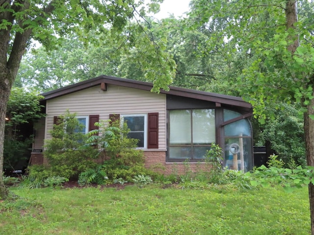 1380 Gertrude Dr, Columbus, OH 43227 - view of home's exterior featuring brick siding and a lawn