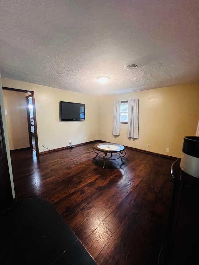 157 Saratoga Dr, Johnstown, OH 43031 - living area with a textured ceiling, wood-type flooring, and baseboards