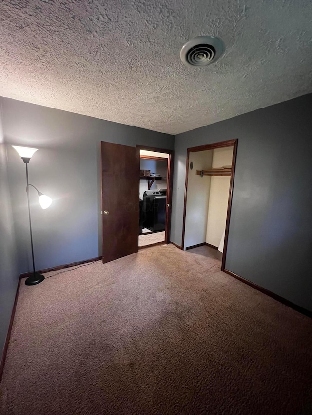 157 Saratoga Dr, Johnstown, OH 43031 - unfurnished bedroom with a textured ceiling, carpet flooring, washing machine and dryer, baseboards, and a closet