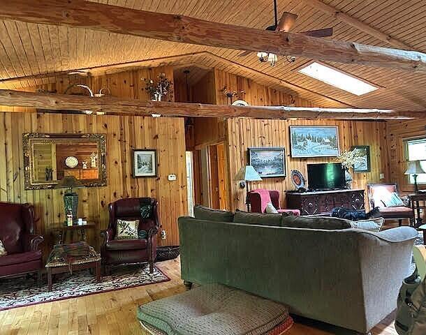 31280 Anglebrook Ln, Logan, OH 43138 - living area with wood walls, wooden ceiling, and hardwood / wood-style floors