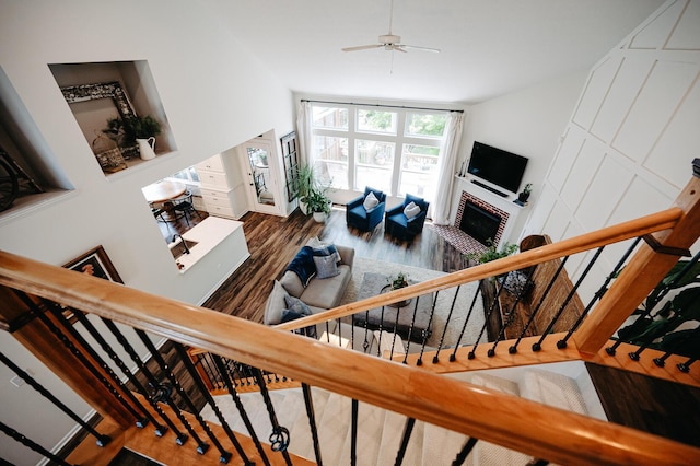 1355 Fisher Run Ct, Columbus, OH 43235 - staircase with lofted ceiling, wood finished floors, a ceiling fan, and a tile fireplace