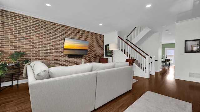 1098 Oregon Ave, Columbus, OH 43201 - living room featuring brick wall, an accent wall, stairway, recessed lighting, and wood finished floors
