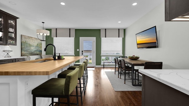 1098 Oregon Ave, Columbus, OH 43201 - kitchen featuring butcher block counters, dark wood finished floors, recessed lighting, glass insert cabinets, and pendant lighting